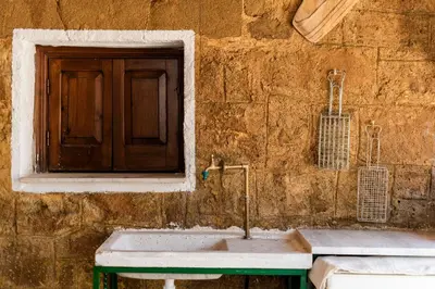 a stone wall with a sink and a window at Hara's Traditional Detached House in Malona in Malona Village