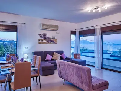 a living room with a couch and a table at Villa Tamara in vlicha
