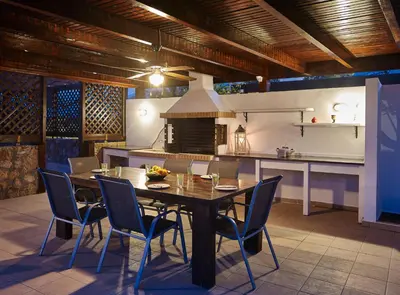 a dining room with a table and chairs in a kitchen at Villa Tamara in vlicha