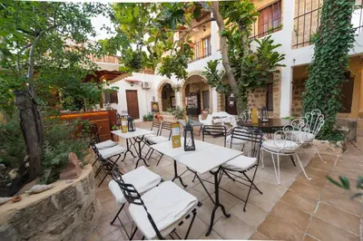 a group of tables and chairs in a courtyard at Kristina´s rooms in Rhodes Town