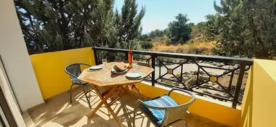 a small table and chairs on a balcony at Villa Irene Lindos, Lindos 10 mins, Beach 4 mins, Amazing Views 0 mins in Kalathos