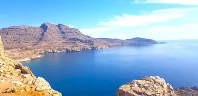 a view of a large body of water with mountains at Villa Irene Lindos, Lindos 10 mins, Beach 4 mins, Amazing Views 0 mins in Kalathos