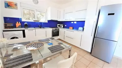 a kitchen with a glass table and a refrigerator at Villa Irene Lindos, Lindos 10 mins, Beach 4 mins, Amazing Views 0 mins in Kalathos