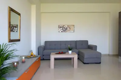 a living room with a couch and a table at Stelia Luxury apartments in Kalavárda