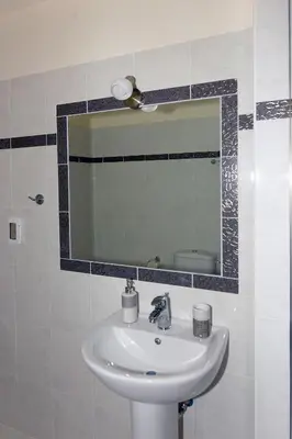 a bathroom with a sink and a mirror at Stelia Luxury apartments in Kalavárda