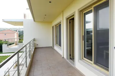 a balcony of a house with glass doors at Stelia Luxury apartments in Kalavárda