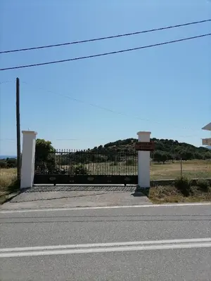 a road with two gates on the side of the road at Katerina Villa In Kiotari in Kiotari