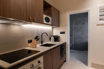 a kitchen with a sink and a stove at Lindian Plumeria in Líndos