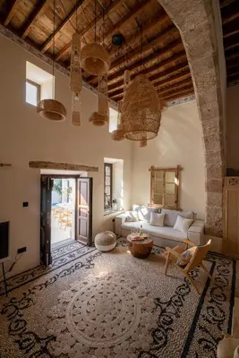 a living room with a couch and a table at Lindian Plumeria in Líndos