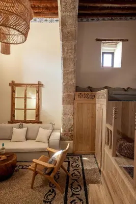 a living room with a couch and a chair at Lindian Plumeria in Líndos