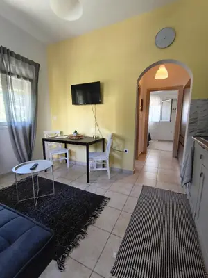 a living room with a couch and a table at Cozy apartment in Triánta
