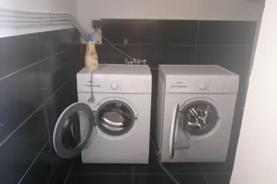 a washing machine and a washer in a bathroom at Cozy apartment in Triánta