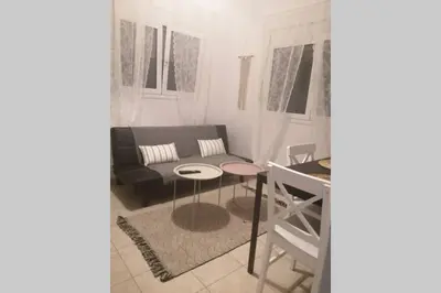 a living room with a couch and a table at Cozy apartment in Triánta