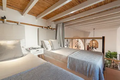 a hotel room with two beds and a balcony at Casa di Giorgio in Kattavía