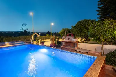 a large blue swimming pool with a gazebo at Margarita luxury apartment 1 in Faliraki