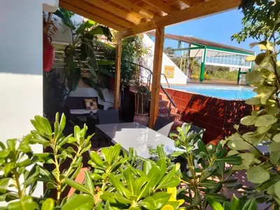 a patio with a table and a swimming pool at Margarita luxury apartment 1 in Faliraki