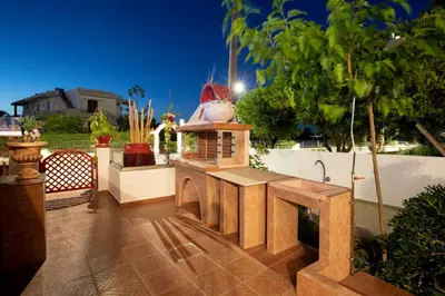 a outdoor kitchen with a stove and a sink at Margarita luxury apartment 1 in Faliraki