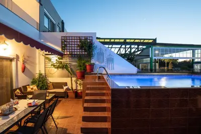 a hotel with a swimming pool and a restaurant at Margarita luxury apartment 1 in Faliraki