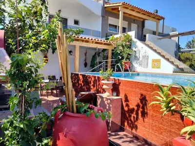 a house with a swimming pool and some plants at Margarita luxury apartment 1 in Faliraki