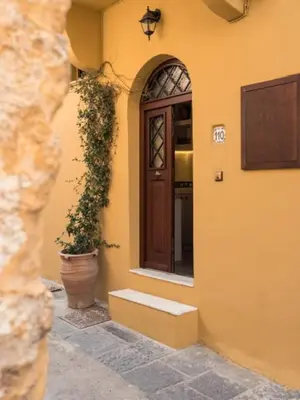 a entrance to a building with a door and a plant at Casa Theano - Old Town in Rhodes Town