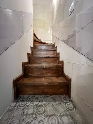 a staircase in a building with a tile floor at Casa Theano - Old Town in Rhodes Town
