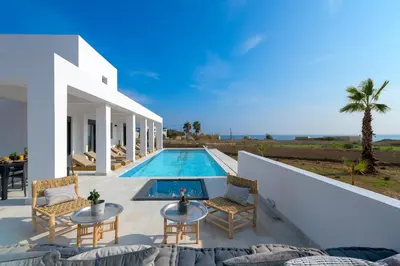 a villa with a swimming pool and a patio at Seawater Villa - Luxury Pool Retreat - 150m Beach in Lachania