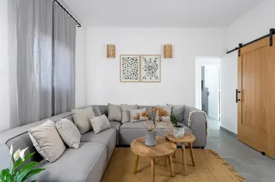 a living room with a couch and a table at Seawater Villa - Luxury Pool Retreat - 150m Beach in Lachania