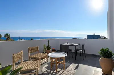 a patio with a table and chairs on a balcony at Seawater Villa - Luxury Pool Retreat - 150m Beach in Lachania
