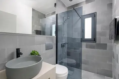 a bathroom with a sink and a toilet and a shower at Seawater Villa - Luxury Pool Retreat - 150m Beach in Lachania