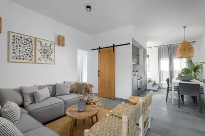 a living room with a couch and a table at Seawater Villa - Luxury Pool Retreat - 150m Beach in Lachania
