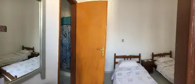 a small room with two beds and a mirror at Electra in Líndos