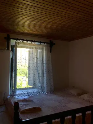 a bedroom with a bed and a window at Electra in Líndos