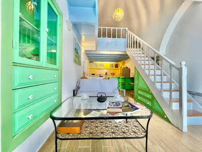 a room with a staircase and a glass table at Seafront - Harbour view , Pitini 2 in Symi