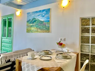 a dining room with a table with dishes on it at Seafront - Harbour view , Pitini 2 in Symi
