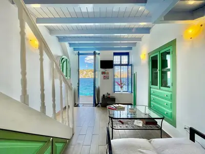 a living room with a view of the ocean at Seafront - Harbour view , Pitini 2 in Symi