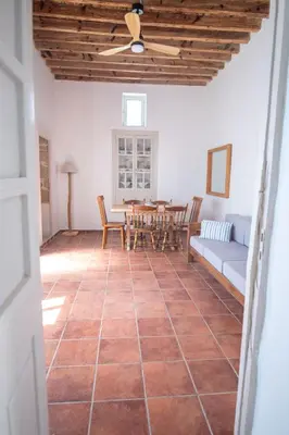 a living room with a table and chairs at Anastasia Traditional House in Lardos
