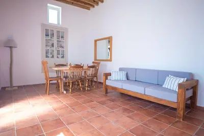 a living room with a blue couch and a table at Anastasia Traditional House in Lardos