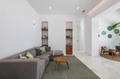 a living room with a gray couch and a table at Seashore Villa - Luxury Beachfront - Pool & Sea View in Lachania