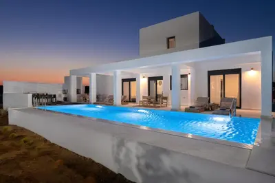 a villa with a swimming pool at night at Seasand Villa - Luxury Pool Retreat - 150m Beach in Lachania