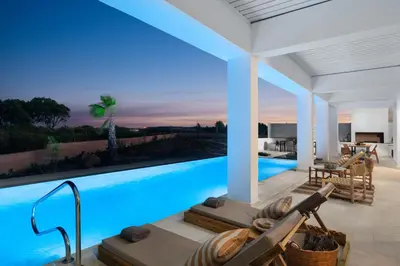 a villa with a swimming pool at night at Seasand Villa - Luxury Pool Retreat - 150m Beach in Lachania