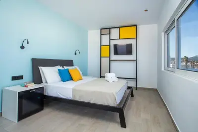 a bedroom with a bed and a window at Faliraki Premium Hotel in Faliraki