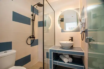 a bathroom with a shower and a toilet and a sink at Faliraki Premium Hotel in Faliraki