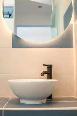 a white sink in a bathroom with a mirror at Faliraki Premium Hotel in Faliraki