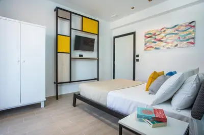a bedroom with a bed and a couch at Faliraki Premium Hotel in Faliraki
