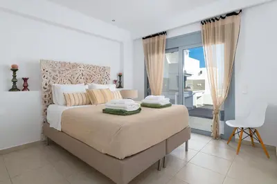 a bedroom with a bed with towels on top of it at Villa Rocabella with heated pool & jacuzzi in Lindos in vlicha