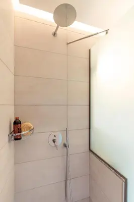 a shower with a glass door in a bathroom at Giorgio Deluxe Studio in Kattavía