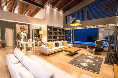 a living room with a white couch and a table at Villa Equinox in Ixia