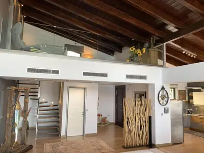 a loft conversion with a staircase in a room at Villa Equinox in Ixia