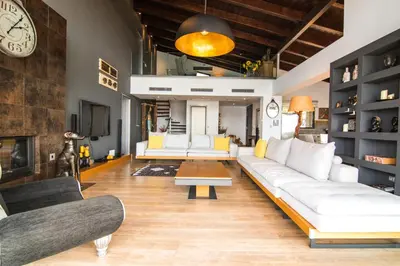 a living room with white couches and a clock at Villa Equinox in Ixia