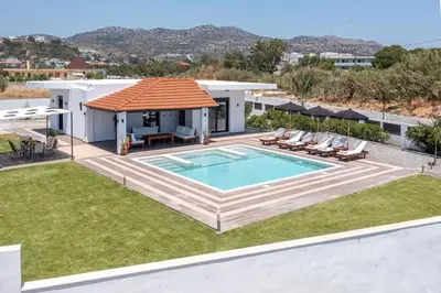 an image of a house with a swimming pool at Elysian Villa in Afantou